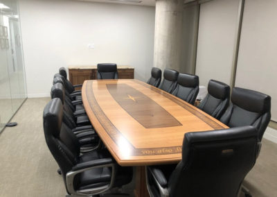 Long conference table with design on table top.